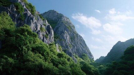 Obraz premium Serene Mountain Landscape with Lush Green Foliage Under a Bright Blue Sky and Soft Clouds in a Peaceful Natural Setting