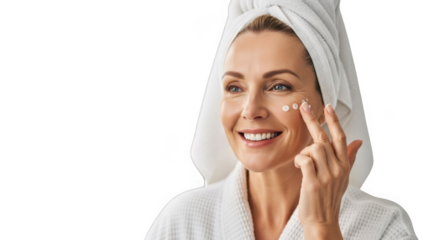 Woman applying cream on her face with a towel on her head, isolated on transparent background