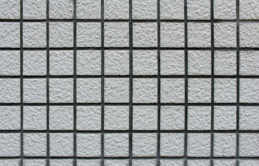 Close up of white square tile wall. Background texture of tile wall.