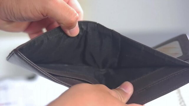 empty wallet without any cash left. empty wallet in the hands of a man. There is no money. small salary, family budget. Poor work, high pay, problems at work. Sad person, depression. Financial problem