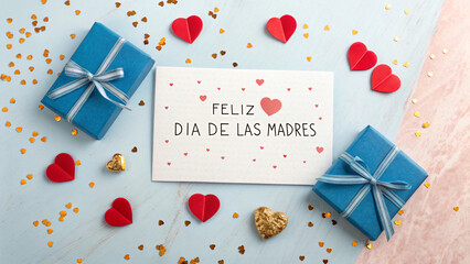 Mother's Day Gift of Love: A heartfelt Mother's Day scene features a greeting card adorned with Feliz Día de las Madres, complemented by wrapped gift boxes and decorative hearts