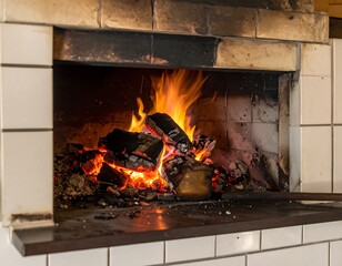 Burning wood in a brick fireplace. Glowing flames and embers in an indoor setting