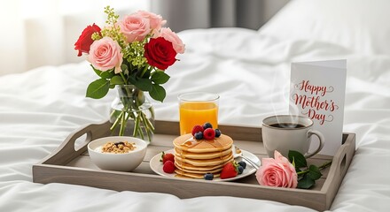Breakfast tray with flowers pancakes and juice on white bed for celebration