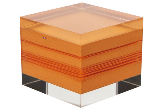 A clear acrylic cube paperweight holding a stack of orange adhesive memo notes isolated on transparent background