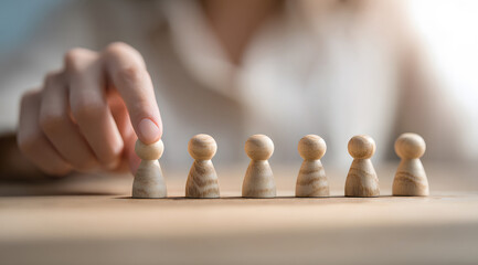 businesswoman sitting at clean modern office table, strategically aligning variety of five mini wooden pawn pieces, symbolizing careful strategic management, focused corporate planning