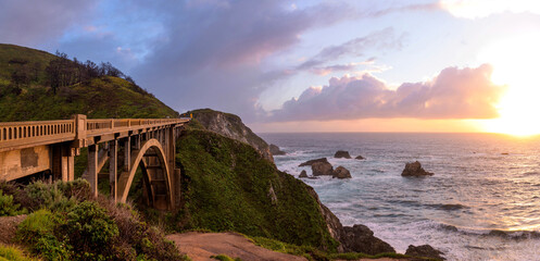 Sunset Rocky Creek Bridge - A panoramic sunset view of Rocky Creek Bridge, known Big Sur Arches, on...