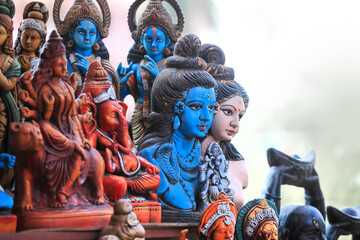 Hand crafted lord Shiva, krishna, Ganesha, Parvathi and other Hindu god idols at display in a market in Bengaluru, India.