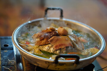 Steaming Hot Pot with Fresh Ingredients and Aromatic Broth Ready to Serve at a Cozy Dining Setting