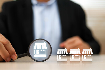 Businessman's hand chooses franchise business e-commerce online e-marketplace or digital marketing branch expansion for growth or analyze product consumer and sale service.