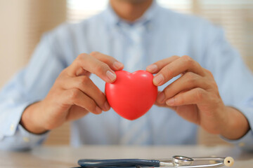 The doctor's hand is choosing the heart for medical health care for safety insurance for sick illness wellbeing protection plan or retirement healthy therapy treatment or health checkup concepts.