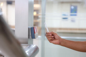 Hand scanning proximity ID card on reader access control system to security door unlock for identity or verification identify for safety detect fingerprint scan or check attendance.