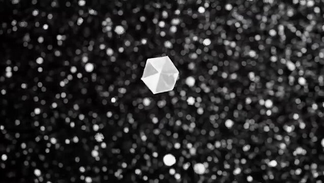 A single white hexagonal snowflake crystal falling gently