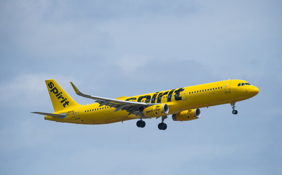 Spirit Airlines aircraft Airbus A321-200 airborne over Dallas Fort Worth International Airport (DFW), blue skies.