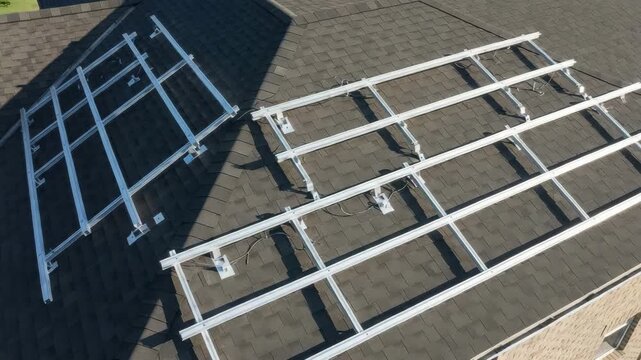 Solar panel mounting rails installed on a shingled roof, ready for photovoltaic panels installation