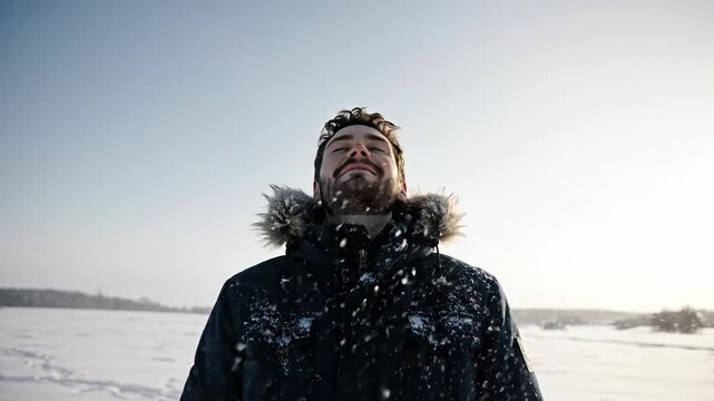 Back view of person in hooded parka walking in blizzard. Adventure and survival concept in cold, snowy wilderness
