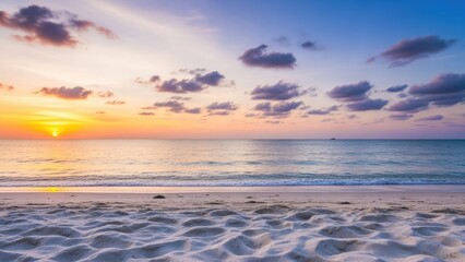 Obraz premium Breathtaking golden hour sunset casting vibrant colors across a tranquil tropical ocean and pristine sandy beach, evoking feelings of peace and natural wonder