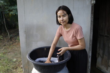 Woman doing laundry in the morning.