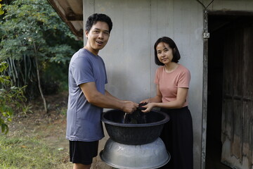 Woman and man washing clothes in the morning.