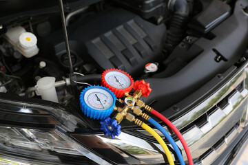 Close-up air refrigerant meter manifold gauge for car care maintenance services and check car air...