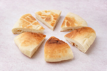 Pieces of tasty pita bread on white background