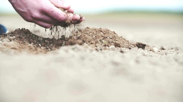 farmer examining earth on his farm. Hand of professional farmer inspecting soil health before planting in farm. hand of person holding abundance soil for agriculture