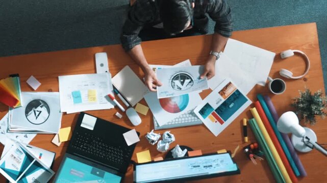 Top down view of designer working on palettes and crumpled paper. Top view of skilled business man run out of idea while sleeping at meeting table. Project manager crumpled and throw paper. Symposium.