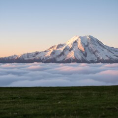 Majestic Mountain Peak Rising Above Clouds: An awe-inspiring image of a towering mountain peak, its snow-covered summit piercing through a sea of fluffy clouds.