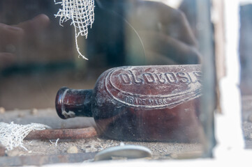Scene from the abandoned ghost town of Body, California. Here, an empty bottle in an abandoned window is shown. 