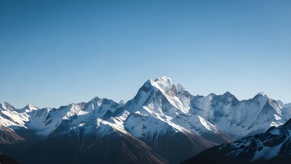 Breathtaking panoramic view of majestic snow-capped mountains under a clear blue sky, showcasing the vastness and serenity of a pristine winter landscape with rugged peaks and deep valleys