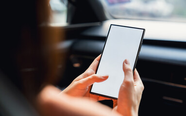 Woman sitting in a private car and hand holding smartphone mockup of blank screen, Take your screen to put on advertising