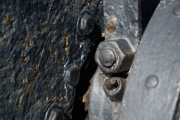 A black metal surface with a bolt on it