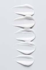 A sample of a white moisturizing cosmetic cream for the body or face with hyaluronic acid