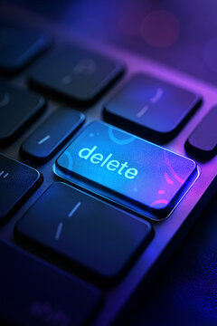 Macro close up of an illuminated delete key on a computer keyboard with modern blue and purple lighting, representing technology, digital concepts, and data control.