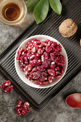 Red Skinned Walnuts in White Bowl on Dark Wooden Tray with Tea Cup - Healthy Nuts Food Photography