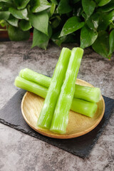 Fresh Green Celery Sticks on Wooden Plate - Healthy Organic Vegetable Snack