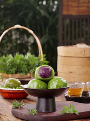 Traditional Chinese Green Dumplings for Qingming Festival with Purple Filling and Tea Service