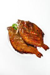 Grilled Spicy Flounder Fish Dish Showcase on White Plate with Parsley Garnish