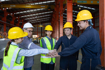 Group of engineers boost customer confidence. Teamwork concept. Group of young businessmen working as a team and shaking hands.