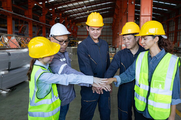 Group of engineers boost customer confidence. Teamwork concept. Group of young businessmen working as a team and shaking hands.
