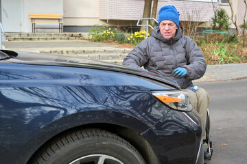 Naklejka premium A man in a wheelchair pulled up to his car.