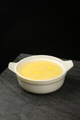 Sweet potato porridge in white bowl on dark background - healthy breakfast comfort food