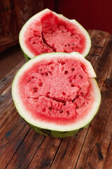 Fresh Cut Watermelon Halves Showing Sweet Red Flesh and Seeds on Wooden Table