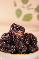 Xinjiang Black Dried Jujubes Chinese Date Fruits in Bowl Traditional Healthy Snack Food Photography