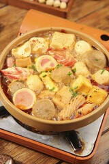 Hot Spicy Shabu Shabu Hot Pot with Meatballs and Variety of Ingredients in Traditional Bowl