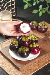 Fresh Thai Mangosteen Fruit on Wooden Board - Exotic Tropical Imported Fruit Display