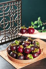 Fresh Purple Mangosteen Fruits from Thailand in Wicker Basket - Exotic Tropical Asian Fruit