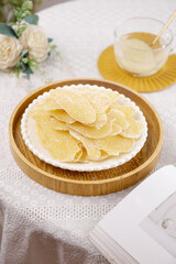 Crystallized Ginger Slices Traditional Sweet Preserves on White Plate with Tea Cup Setup