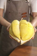 Fresh Golden Durian Fruit from Thailand Held in Hands Showing Creamy Yellow Flesh Segments