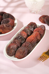 Xinjiang Black Dried Apricots Preserves in White Bowls Traditional Chinese Fruit Snack