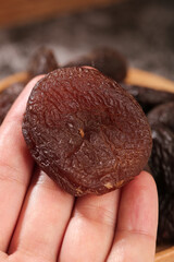 Dried Candied Apricot from Xinjiang China Held in Hand Close-up